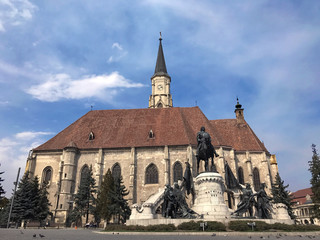 Cluj-Napoca, Romania. Matthias Corvinus Monument in front Church of Saint Michael, a Gothic-style...