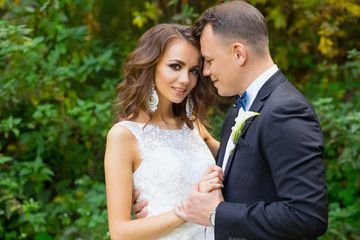 Elegant curly bride and stylish groom