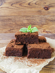 Sliced brownie decorated with cocoa powder and mint