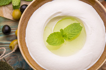 House cottage cheese with addition of olive oil with garlic and mint
