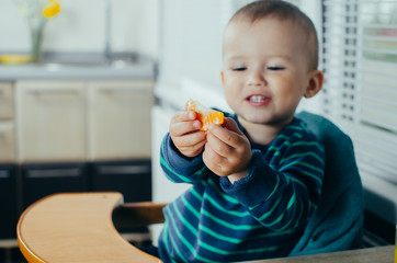 baby eating Mandarin