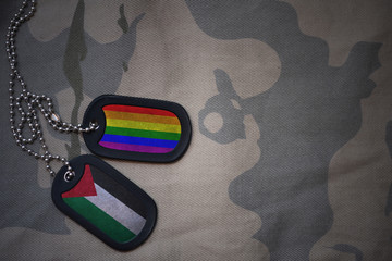 army blank, dog tag with flag of palestine and gay rainbow flag on the khaki texture background....