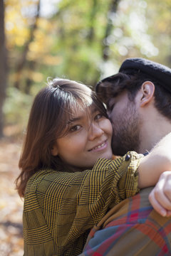 Man kissing his girlfriend outdoors