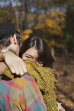 Happy young couple embracing in a park
