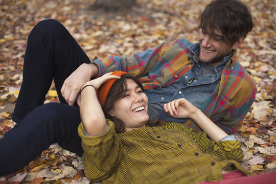 Happy young couple relaxing at park