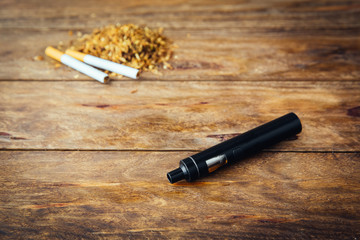 E-cigarette or vaping device on wooden surface, natural light
