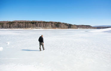 Man walking on a frozen lake