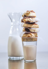 Sweet cinnamon rolls stacked on a milk glass