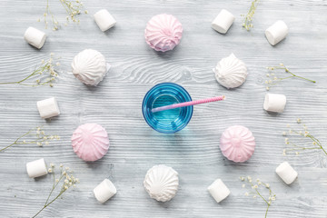 woman table design with cocktail and marsh-mallow soft light top view pattern