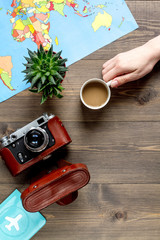 tourist stuff with camera and map on wooden background top view mockup