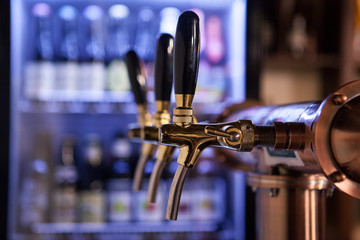 A lot of Golden beer taps at the bar