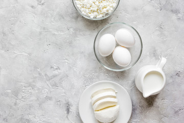 Fresh dairy products on stone table background top view mock up
