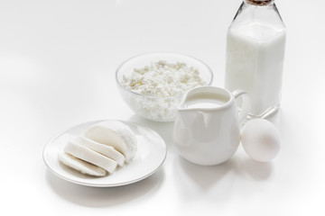 monochrome concept with dairy products on white table