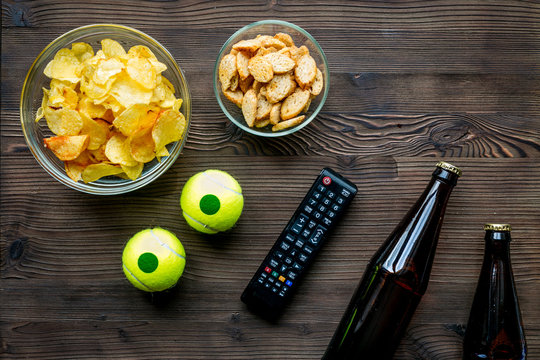 snacks for watching sport match on wooden background top view mock-up
