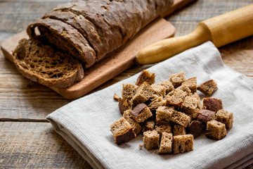 Dried crumbs with bread on kitchen table background