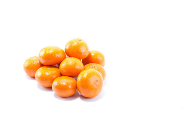 Fresh stack of shinning orange mandarins isolated in white background