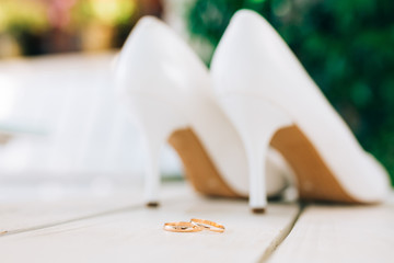 Wedding rings and wedding shoes bride. Wedding jewelry.