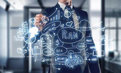 Businessman sketching his ideas . Mixed media