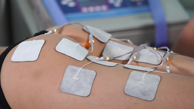 Close up shot of electro stimulation treatment in beauty salon. Regain beauty procedure of female butt. Hardware cosmetology.