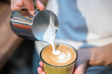 Making of cafe latte art, leaf shape
