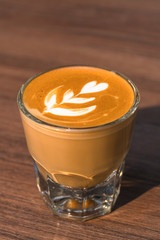 cup of latte coffee on wood table
