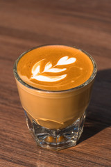 cup of latte coffee on wood table
