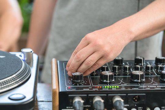 DJ at work playing music with a mixer
