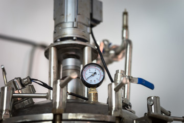 Pressure gauge, measuring instrument close up on pump system.