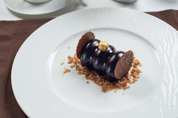 chocolate cake on a white plate . white tea set