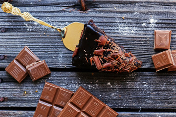 Brown milk chocolate on a wooden table.