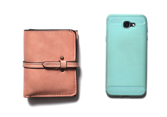Pink purse and smartphone in a blue cover isolated on white background.
