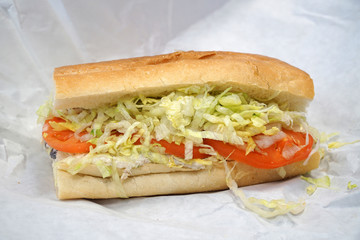 fresh chicken sandwich with vegetable in the wrapping paper