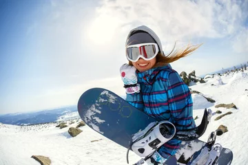 Acrylic prints Winter sports Girl snowboarder enjoys the ski resort