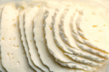 Closeup slices of brined cheese