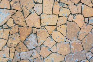 Closeup wall covered in pieces of stone background
