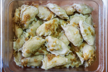Close up vareniki or Russian dumplings with onion