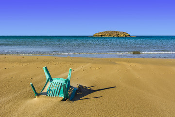 Fototapeta na wymiar Chair in the Sand of Beach