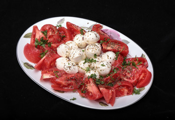 Caprese salad with tomatoes,  mozzarella and herbs