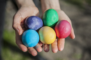 Fototapeta na wymiar Female hands holding colorful Easter eggs