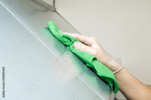 Hand In Protective Glove With Rag Cleaning Kitchen Equipment