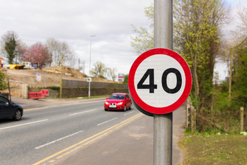 British 40 Mile per hour restricted traffic zone with defocussed vehicles