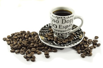 Coffee cup and coffee beans laying on white background