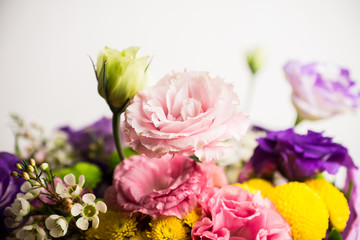 Bouquet with a lot of different flower on the wooden background. Shallow depth of field.