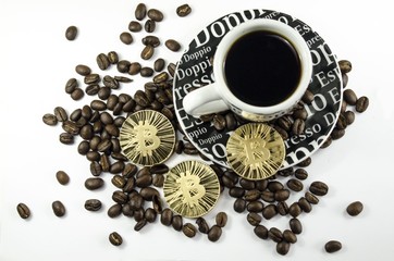 Coffee beans, cup and bitcoin coins laying on white background
