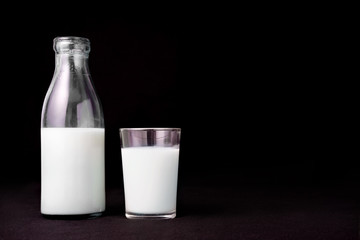 Bottle of milk  glass black background copy space