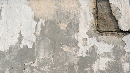 background of natural cement plaster on the wall grey plain textured with cracks in the upper right corner