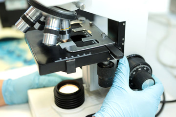 Medical microscope. Professional pharmaceutical microscope. Study of the properties of the drug when increasing. The person analyzes the components of the medicine.