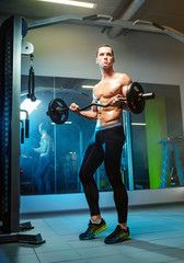 Closeup portrait of a muscular man workout with barbell at gym. Sport, workout.