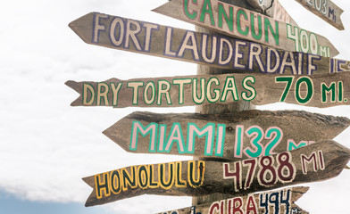 Key West beach distance signs to worldwide landmarks in Fort Zachary Taylor Park - Florida, USA