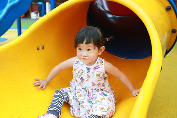 toddler girl playing on the slider